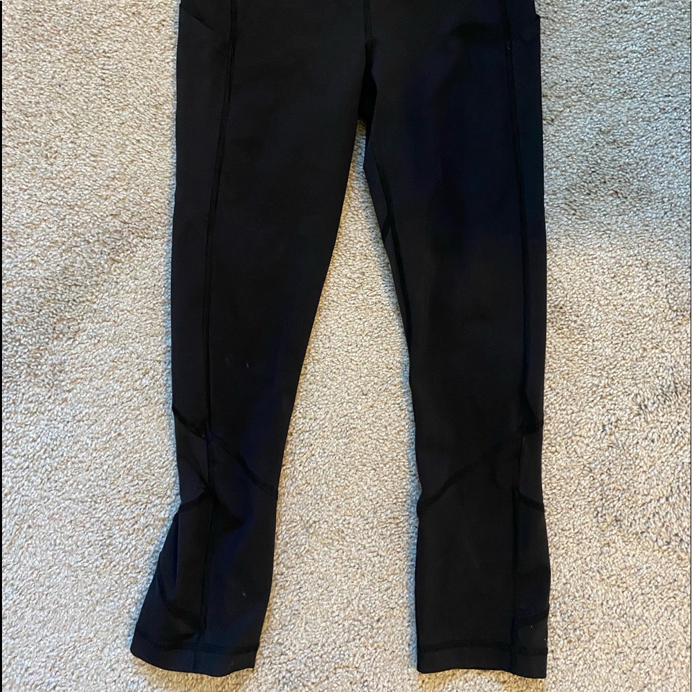 Lululemon black crop leggings. Mesh cut out. Size 4